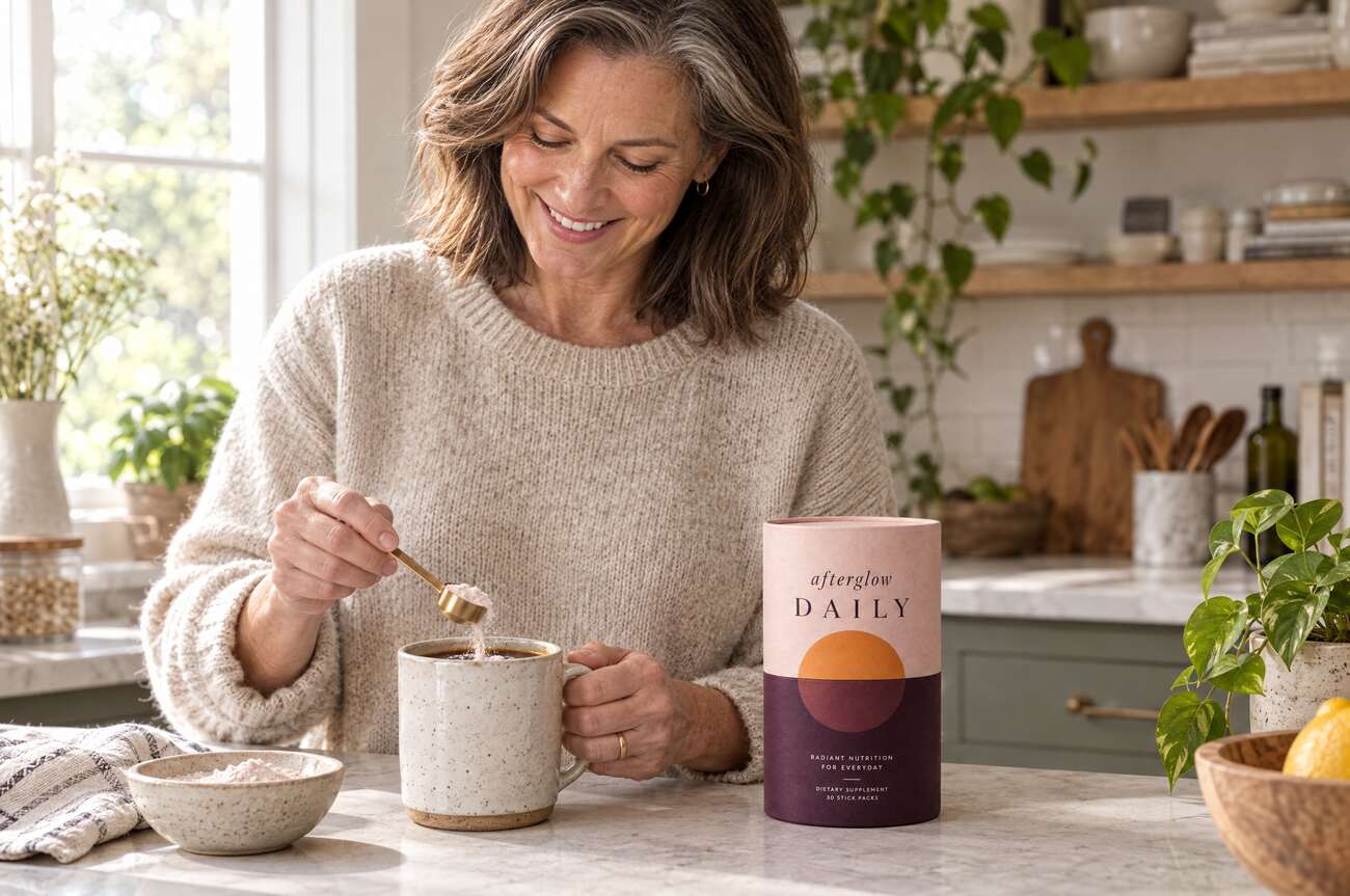 A woman stirring Afterglow into her morning coffee at the kitchen counter