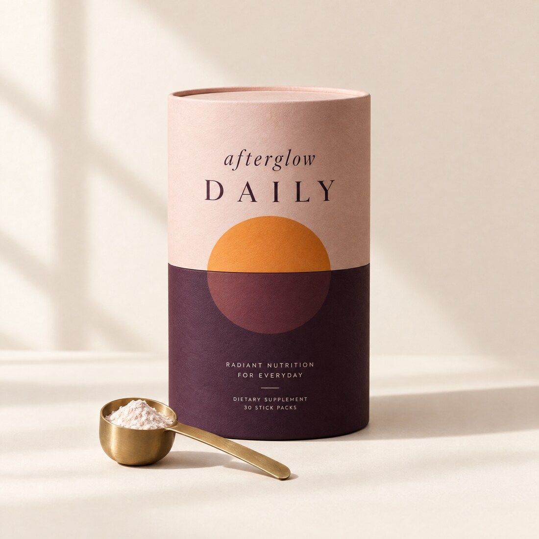 afterglow DAILY tub with a brass scoop of powder